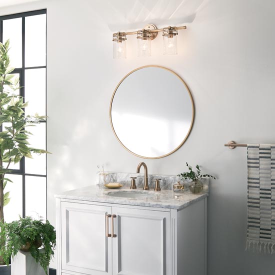 bathroom with round mirror and lighting